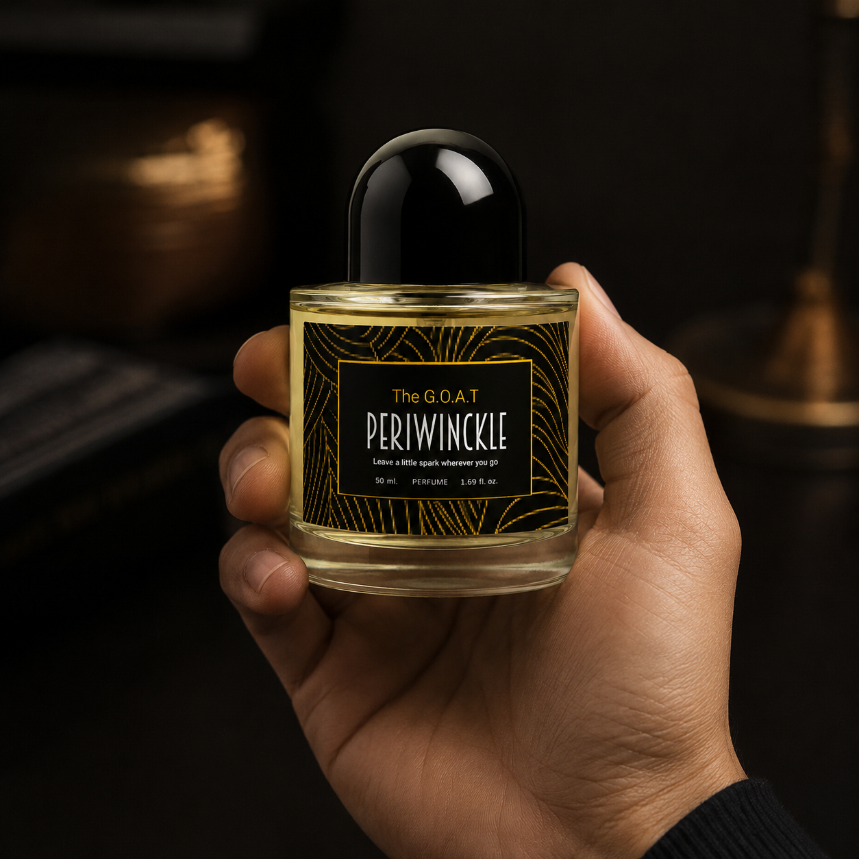 The G.O.A.T 50ml Periwinckle parfum bottle held in hand for scale